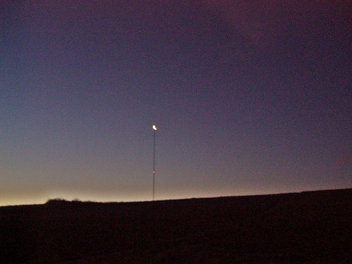 Maszt pomiarowy o zachodzie księżyca.Dwa światła na maszcie są zasilane panelami słonecznymi.W roku 2012/13 planowana budowa farmy wiatrowej w Szczeglicach.